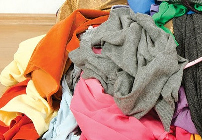 Recycled wool projects start with sorting the garments by color